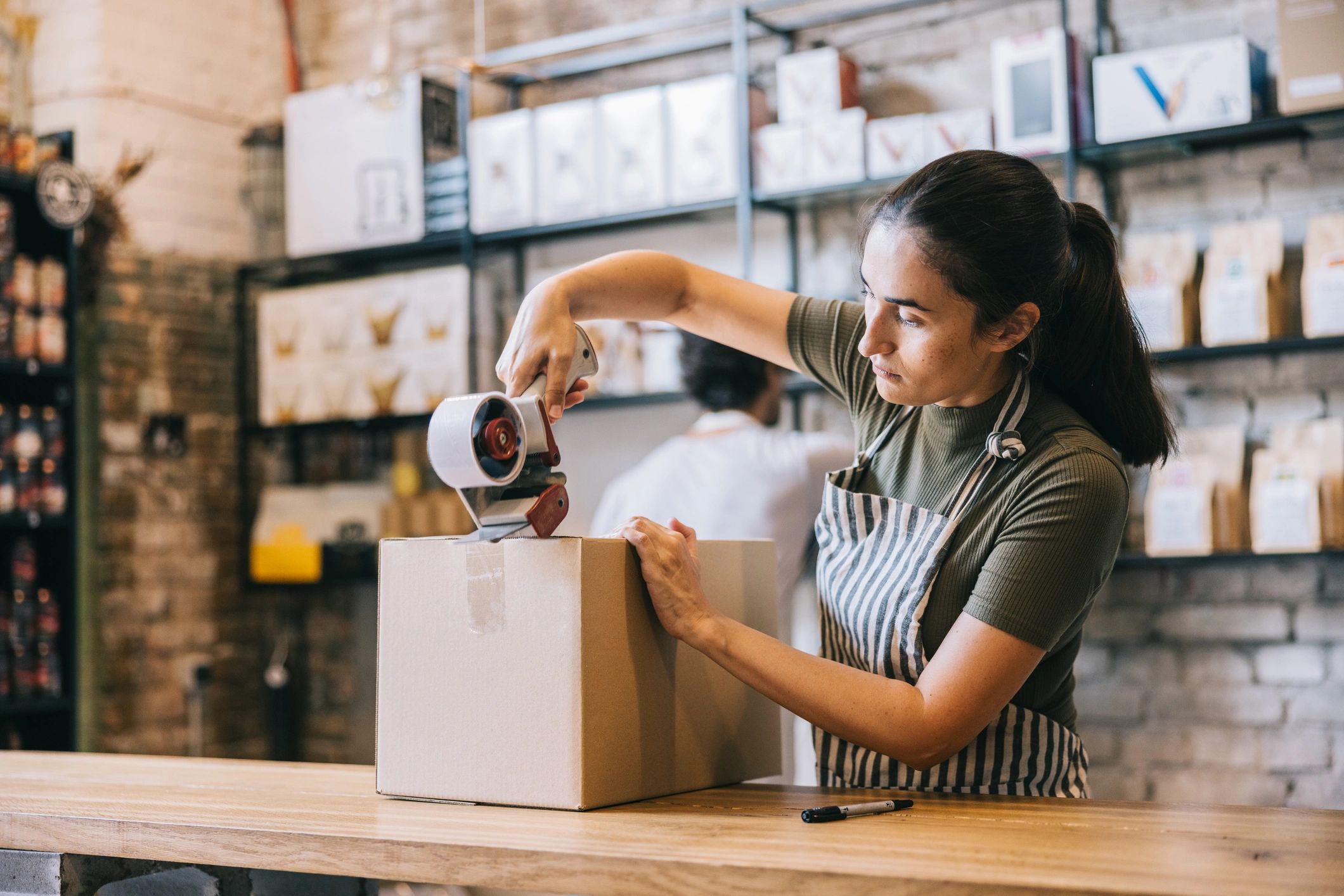 Small business owner packing an order for shipping